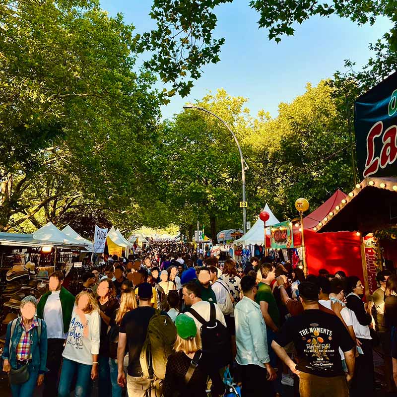 Crowded outdoor festival (Karnaval Der Kulturen) under trees